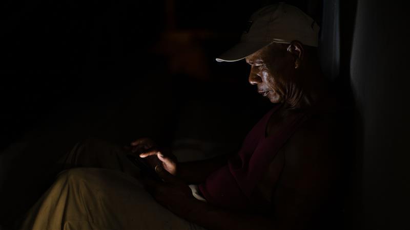 After dinner, Lee passes the time waiting for the next net to come up. Fishing is often a lonely profession.